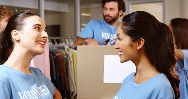 Smiling Volunteers Sorting Donations at Community Center - Download Free Stock Images Pikwizard.com