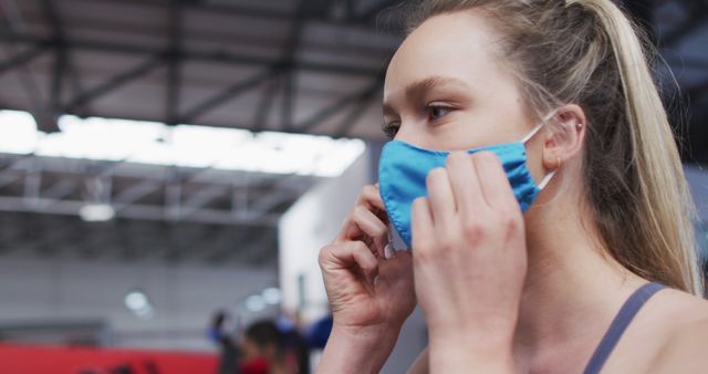 Close-Up of Woman Wearing Face Mask in Gym with Modern Interior - Download Free Stock Images Pikwizard.com