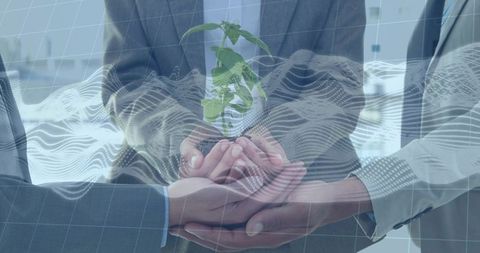 Business leaders nurturing green seedling in cupped hands with digital data overlay visual