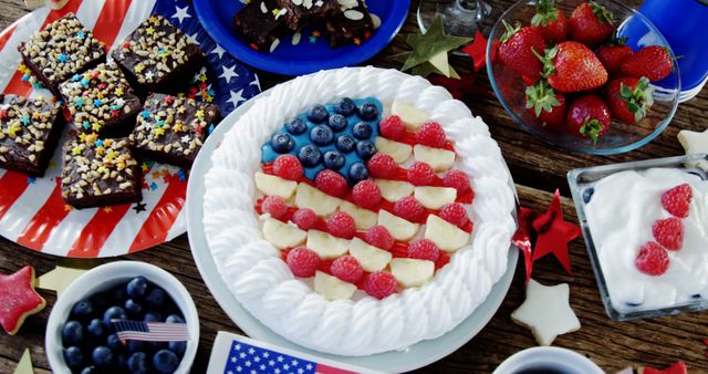 Fruitcake and various sweet foods arranged on wooden table with 4th July theme - Download Free Stock Photos Pikwizard.com