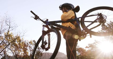 Cyclist Carrying Mountain Bike While Sunset Adventure Awaits - Download Free Stock Images Pikwizard.com