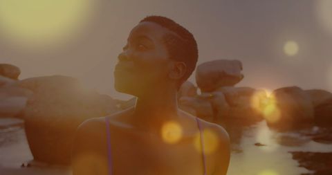 African American Woman Enjoys Serene Coastal View at Sunset