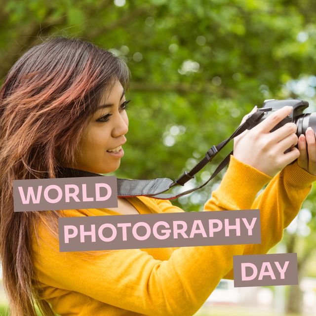 Young Asian woman smiling and taking photos with a camera in a peaceful park, perfect for celebrating World Photography Day. Great for blog posts, social media content, photography tutorials, and articles focusing on hobbies, female photographers, and outdoor activities.