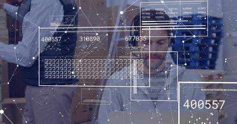 Data analyst in office analyzing digital information with transparent overlays