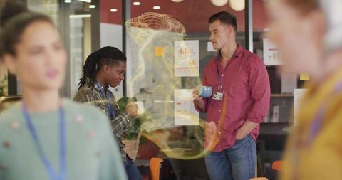 Diverse professionals discussing ideas over coffee in modern office lounge