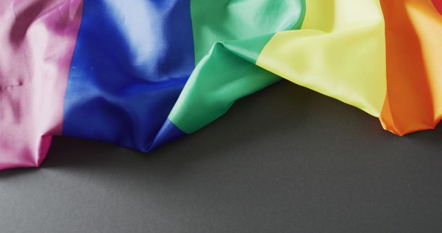 Image of rainbow wrinkly fabric over grey background with copy space. Gender, lgbt, queer, gay pride and equality concept.