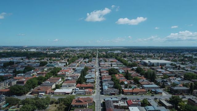 Aerial Panorama of Suburban Neighborhood with Central Roadway