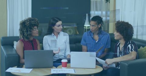 Diverse Team Analyzing Financial Data with Technological Overlays