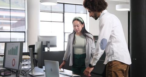 Two Professionals Collaborating in Modern Office Workspace