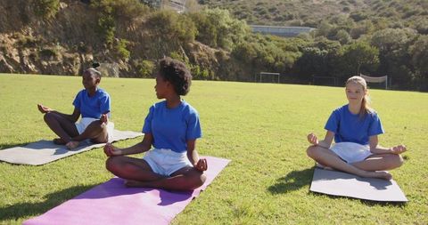 Children meditating outdoors for relaxation and wellness