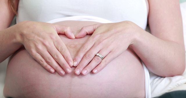 Pregnant Woman Forming Heart Shape on Belly with Hands - Download Free Stock Images Pikwizard.com