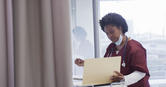 African American Nurse Wearing Scrubs Working on Laptop in Hospital - Download Free Stock Images Pikwizard.com