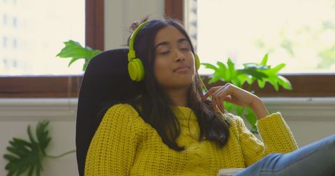 Content Woman Relaxing with Music at Workstation