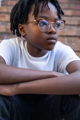 African American Teen Contemplating in Urban Setting