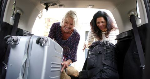 Senior Women Packing for Adventure Road Trip - Download Free Stock Images Pikwizard.com