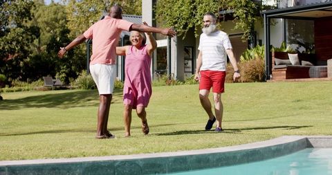 Joyful Reunion of Friends by Poolside During Sunny Day