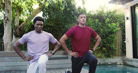 Diverse friends exercising outdoor by pool in summer