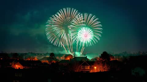 Vivid Fireworks Burst Over Suburban Homes at Night