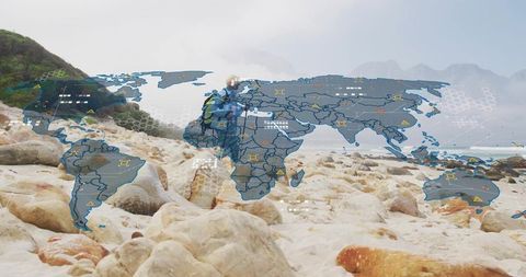 Woman hiker standing on rocky shore with digital world map overlay