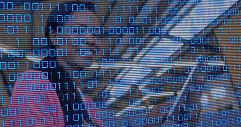 Smiling woman holding tablet in modern workspace with blue binary data overlay on shelving