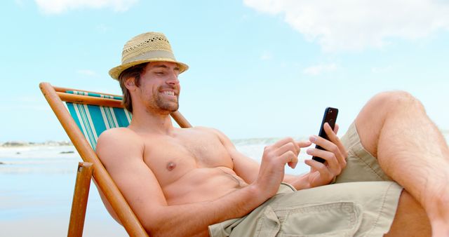 Relaxed Man Using Smartphone on Beach Deck Chair - Download Free Stock Images Pikwizard.com