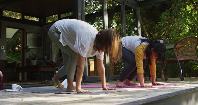 Women Practicing Yoga Outdoors in Sunlit Patio - Download Free Stock Images Pikwizard.com