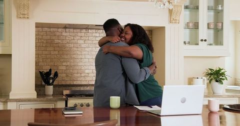 Happy couple embracing in spacious kitchen