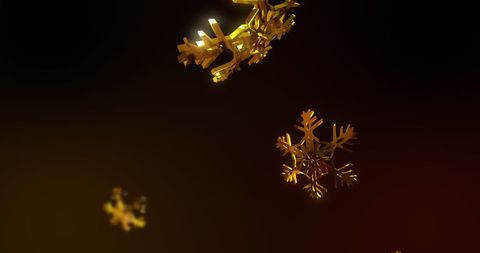 Glittering Gold Snowflakes Against Dark Background
