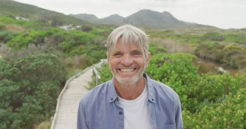 Senior Man Smiling on Nature Path in Countryside