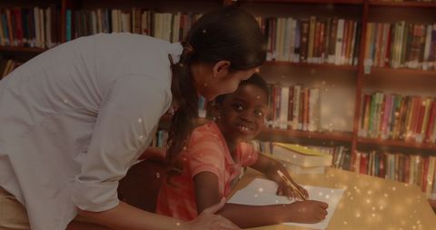 Female Teacher Assisting Schoolboy in Library with Learning