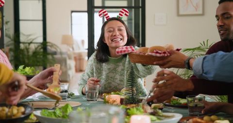 Diverse group celebrating with meal and festive accents