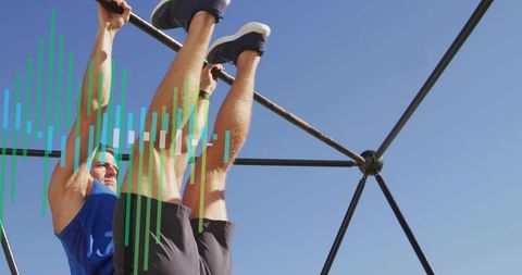 Mid-adult man performing hanging leg raises on geodesic playground dome under clear blue sky