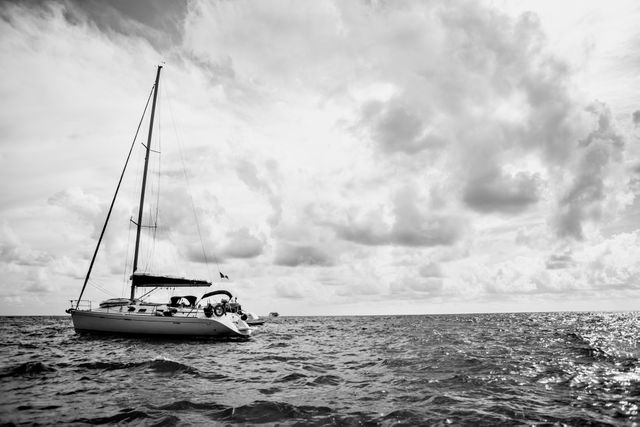 Sailing Yacht in Open Sea Under Cloudy Sky in Black and White - Download Free Stock Photos Pikwizard.com