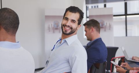 Confident Businessman Smiling During Office Meeting - Download Free Stock Images Pikwizard.com