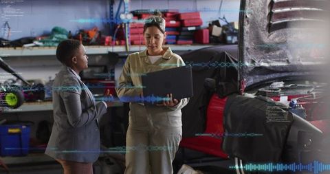Female Mechanic Diagnosing Vehicle with Laptop While Consulting Business Professional