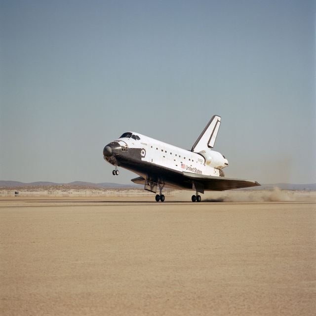 Space Shuttle Atlantis lands on dry lakebed at Edwards Air Force Base after completing STS 51-J mission. This historic touchdown marks the successful conclusion of a NASA mission focused on space exploration. Photo highlights the shuttle's landing, showing its importance in aerospace history and space science advancements. Useful for articles on space travel, NASA missions, aerospace education, and historical events in aviation.