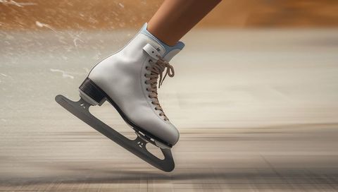Figure Skate Gliding on Smooth Rink with White Leather Boot and Flashing Blade