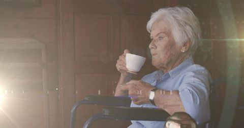 Senior Woman Reflecting While Drinking Tea in Sunlit Room - Download Free Stock Images Pikwizard.com