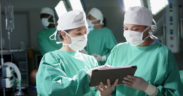 Surgeons Using Digital Tablet During Operation in Modern Operating Room - Download Free Stock Images Pikwizard.com