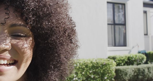 Close-Up of Half Smiling Woman with Curly Hair Outdoors - Download Free Stock Images Pikwizard.com