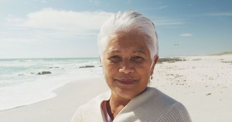 Happy Senior Woman Enjoying a Sunny Beach Day