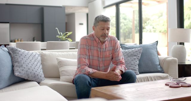 Man Sitting on Sofa Reflecting in Modern Living Room - Download Free Stock Images Pikwizard.com