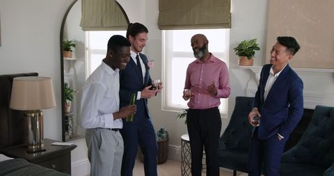 Friends Enjoying Drinks and Laughter in Elegant Home Setting