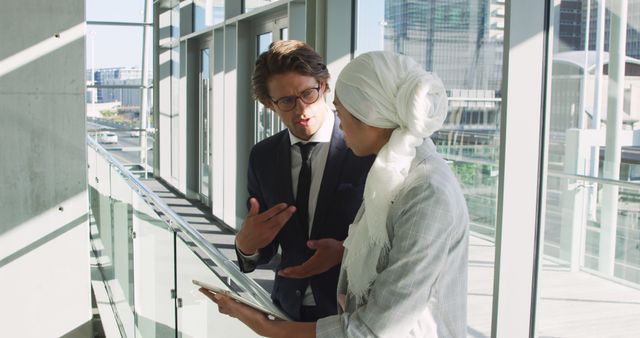 Business professionals discussing digital tablet in modern office - Download Free Stock Images Pikwizard.com