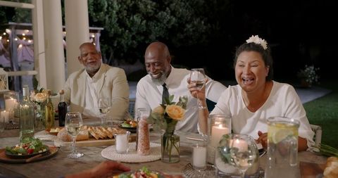 Joyful seniors dining outdoors, celebrating friendship