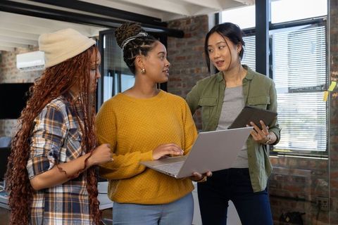 Diverse Team Discussing Project in Modern Loft Office
