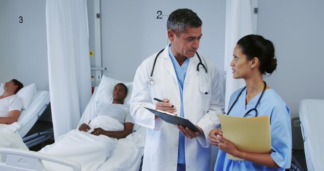 Doctors Discussing Patient Care Plans in Hospital Ward - Download Free Stock Images Pikwizard.com