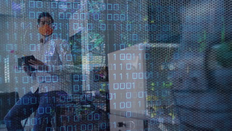 Man Wearing Face Mask While Binary Code Projects Over Screen