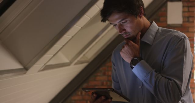 Man Using Tablet While Standing in Loft - Download Free Stock Images Pikwizard.com