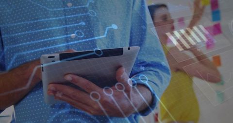 Holding tablet while collaborating with team using holographic data visualization